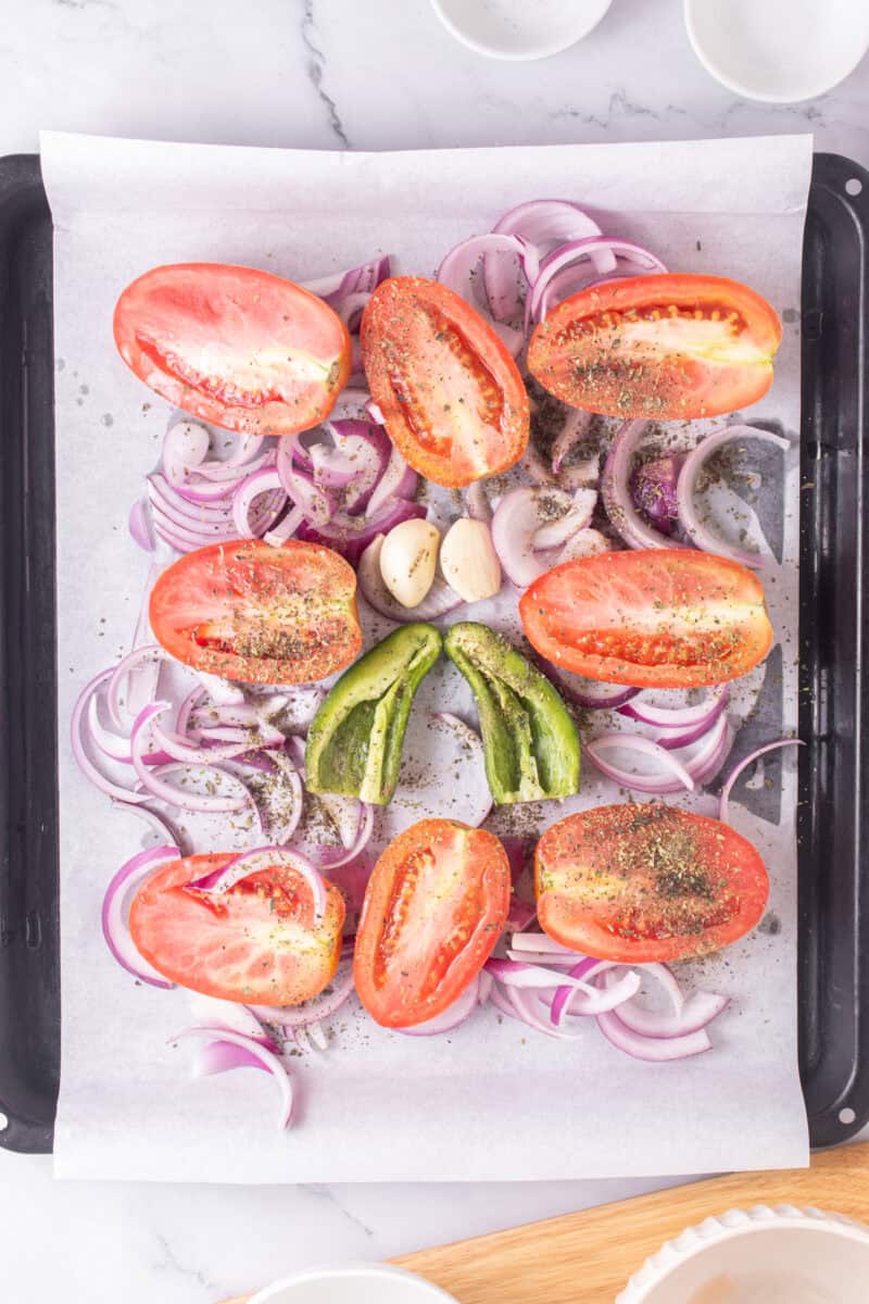 ingredients for roasted tomato salsa on a baking sheet