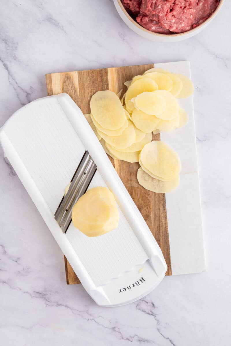 Slicing potatoes with a mandoline