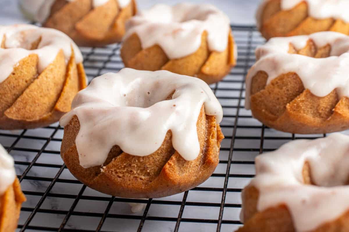 Glazed pumpkin bundt cakes on a cooling rack